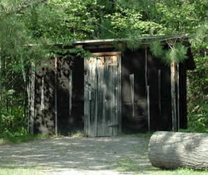 Color photo of an outhouse at the Forest History Center
