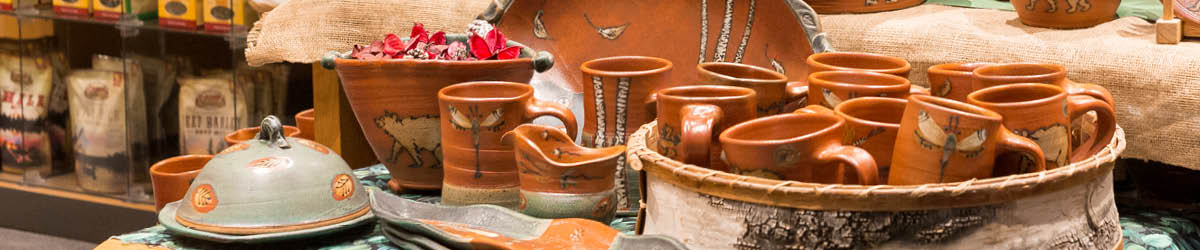 A collection of brown ceramic pottery on display in the Minnesota History Center shop.