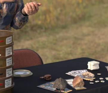 guest examines artifacts