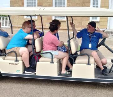 folks on a golf cart at Historic Fort Snelling