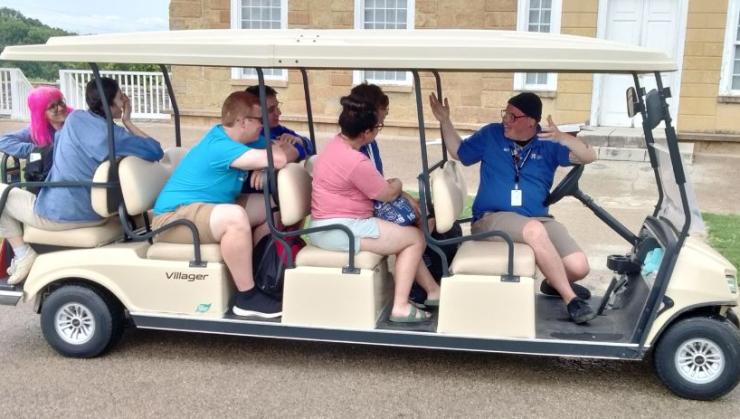 folks on a golf cart at Historic Fort Snelling