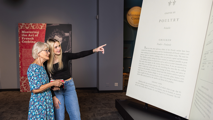 Visitors looking at the big recipe at the Julia Child Exhibit.